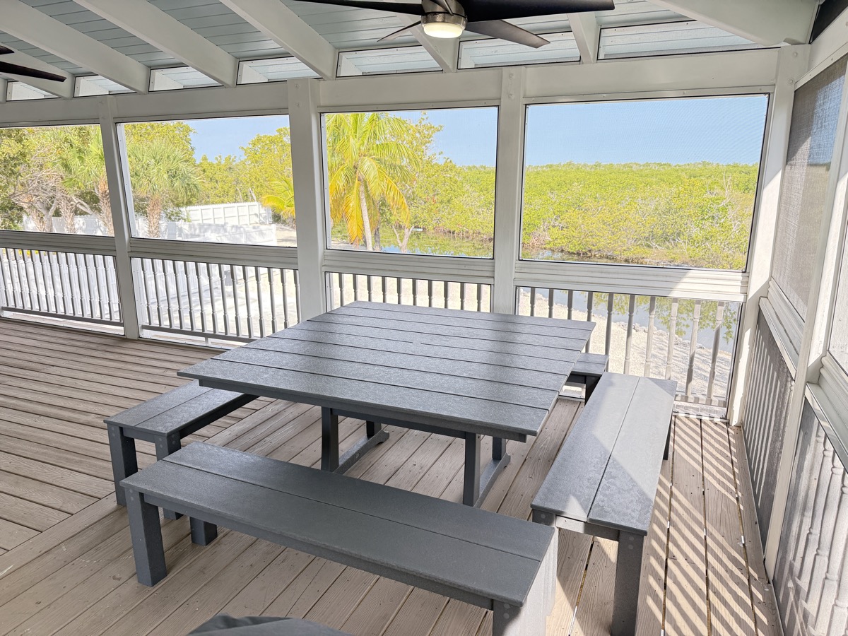 Screened porch dining table with preserve views