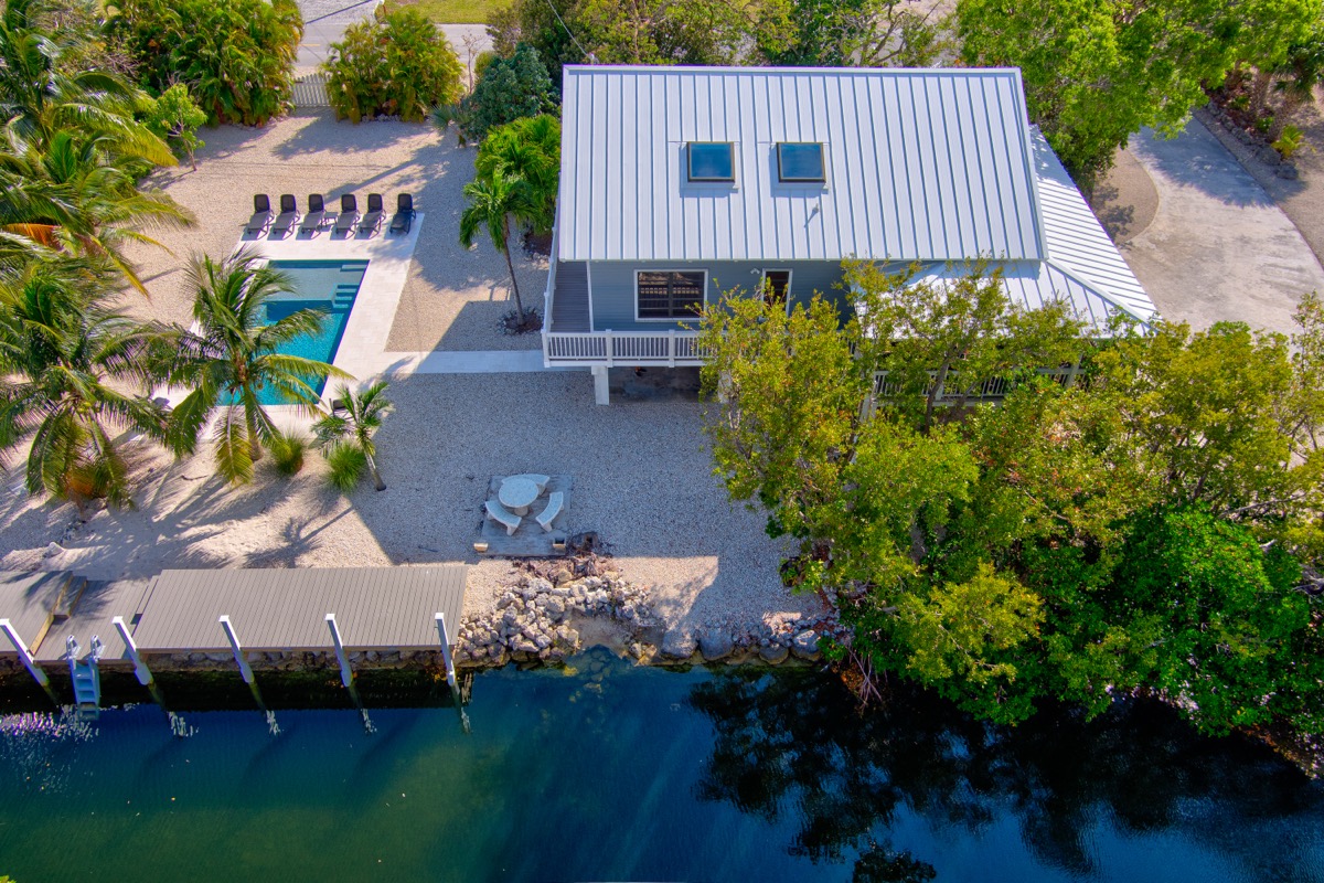 Aerial view of Finding Remo estate showing pool, dock, and canal